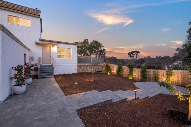 yard at dusk with a patio