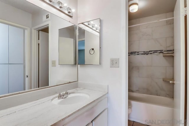 full bathroom with tile patterned floors, toilet, vanity, and tiled shower / bath