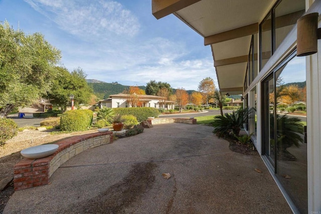 view of patio / terrace featuring a mountain view