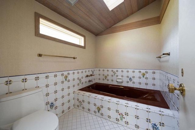 bathroom with lofted ceiling, tiled tub, tile patterned flooring, wooden ceiling, and toilet