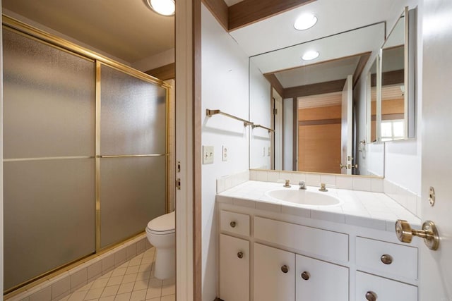 bathroom with an enclosed shower, vanity, tile patterned flooring, and toilet