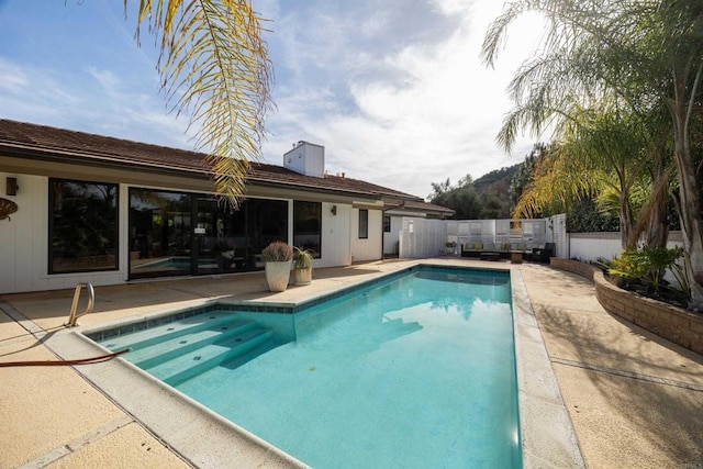 view of swimming pool with a patio area