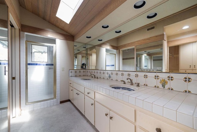 bathroom with wood ceiling, backsplash, lofted ceiling with skylight, vanity, and walk in shower