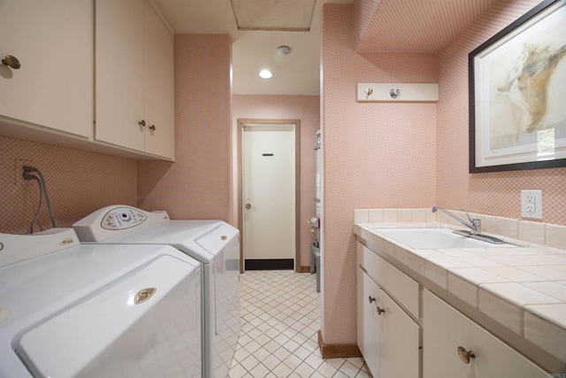 laundry room with sink, cabinets, and washing machine and clothes dryer