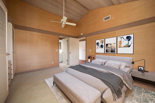 carpeted bedroom featuring high vaulted ceiling, ensuite bath, wood ceiling, ceiling fan, and beam ceiling