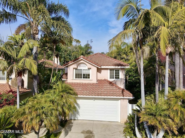 mediterranean / spanish-style home with a garage