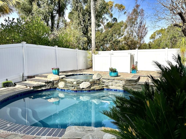 view of swimming pool featuring an in ground hot tub