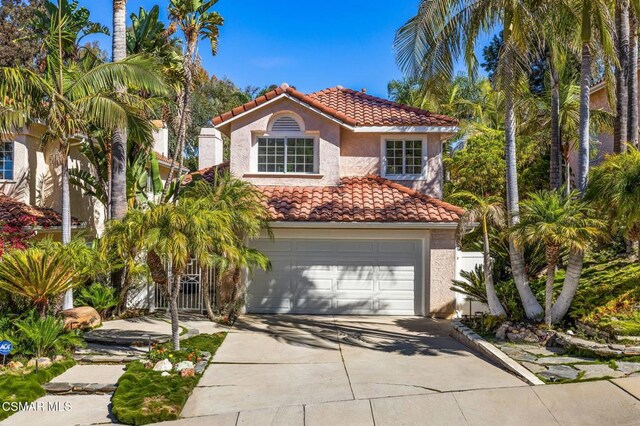 mediterranean / spanish home featuring a garage