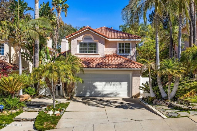 mediterranean / spanish home featuring a garage