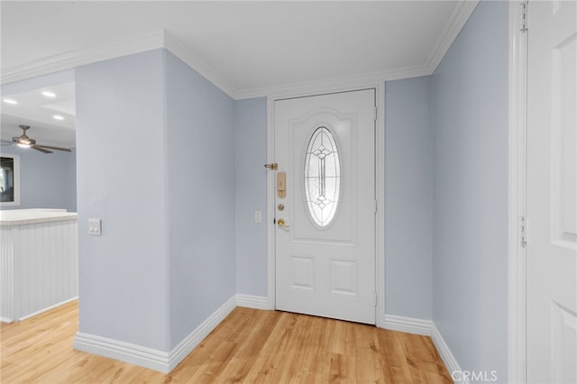 entrance foyer with ceiling fan, crown molding, and light hardwood / wood-style floors