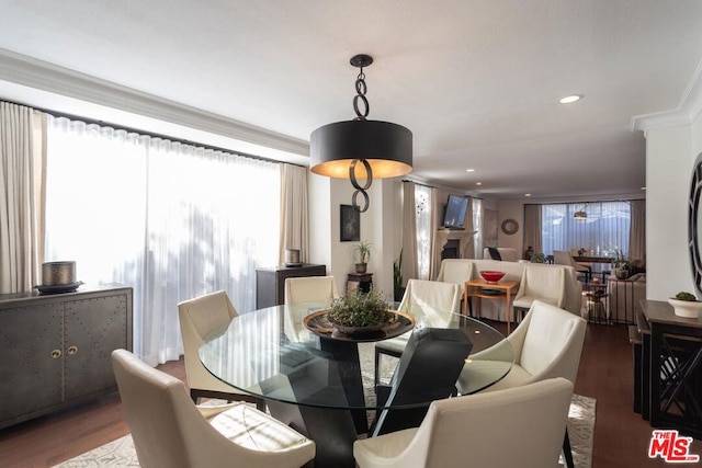 dining space featuring dark hardwood / wood-style floors and crown molding