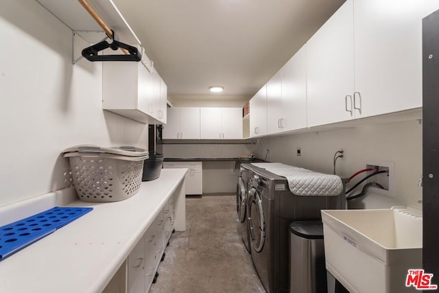 clothes washing area featuring cabinets, separate washer and dryer, and sink