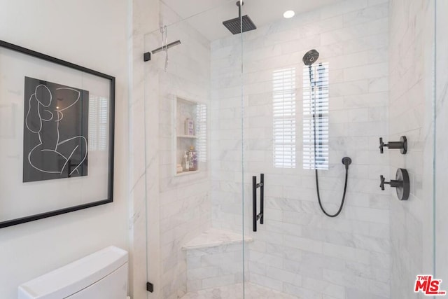 bathroom featuring toilet and walk in shower