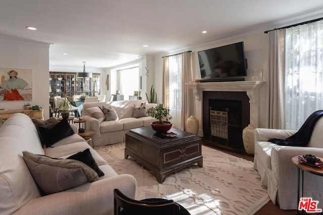 living room with light hardwood / wood-style floors and ornamental molding