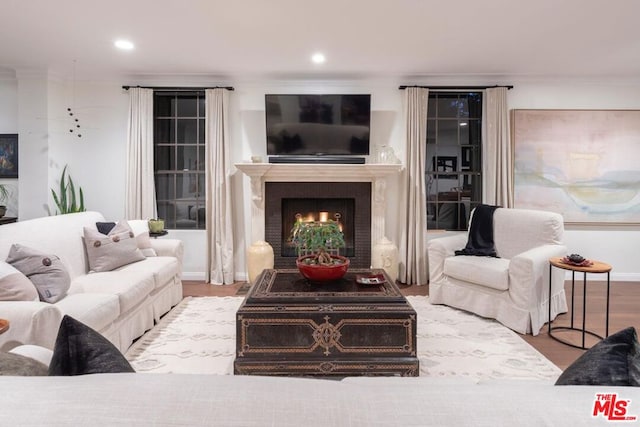 living room featuring ornamental molding and light hardwood / wood-style flooring