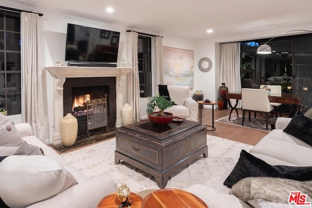 living room featuring ornamental molding and light hardwood / wood-style floors