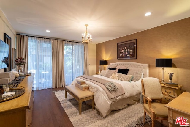 bedroom featuring an inviting chandelier and wood-type flooring