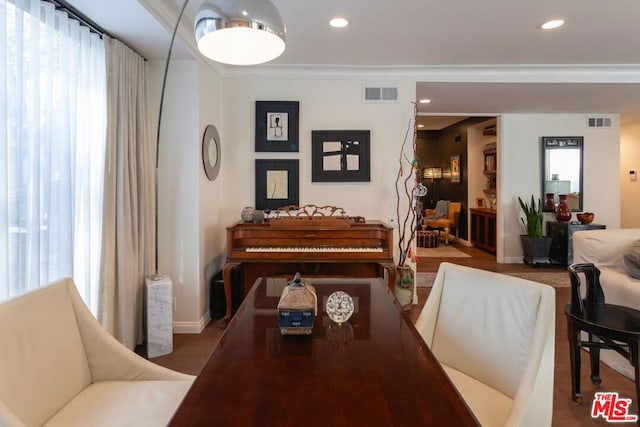 dining area featuring ornamental molding and hardwood / wood-style floors