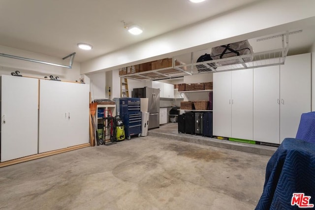 garage with stainless steel fridge