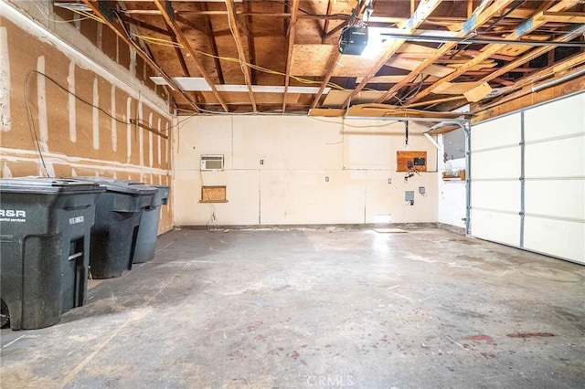 garage featuring an AC wall unit and a garage door opener