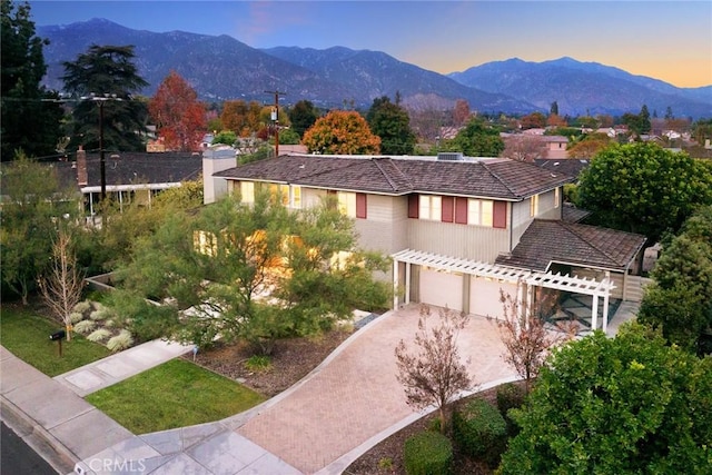 view of front of property featuring a mountain view and a garage