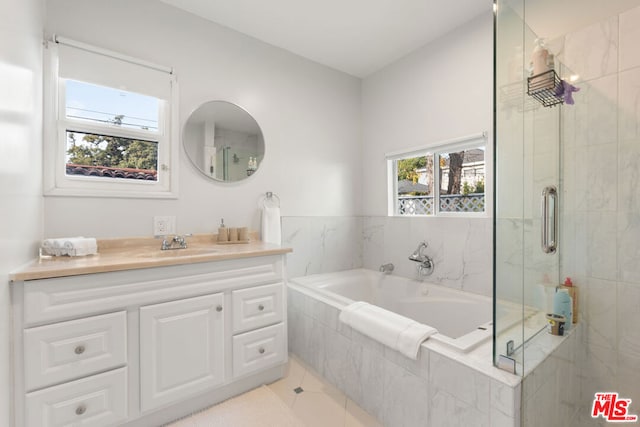 bathroom featuring vanity, tile patterned flooring, and independent shower and bath