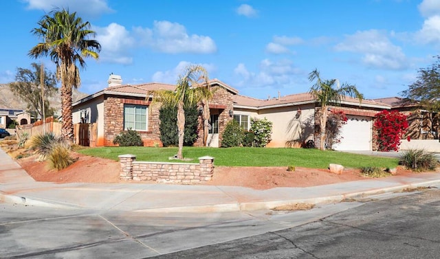 view of front of house with a garage and a front lawn