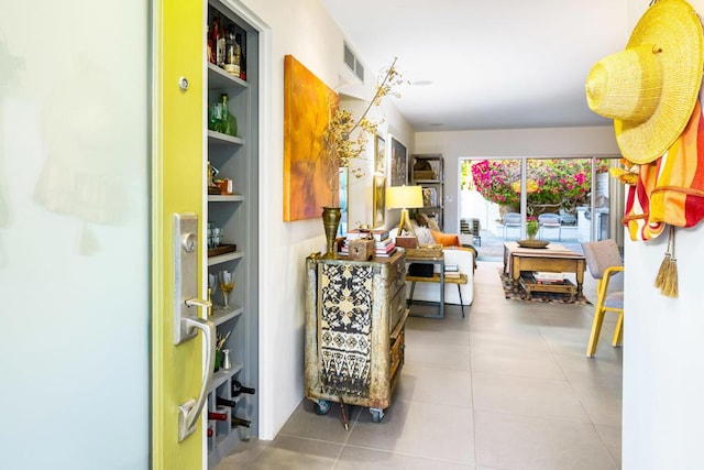 hallway with built in shelves and tile patterned flooring