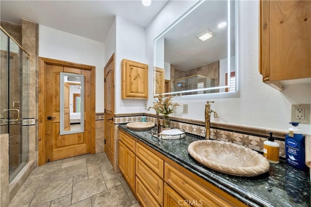 bathroom featuring walk in shower and vanity