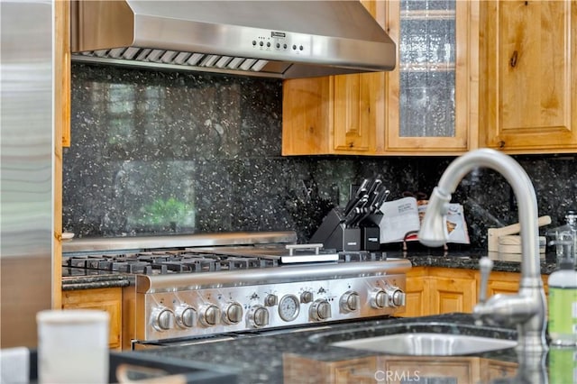 details with wall chimney range hood, range, and tasteful backsplash