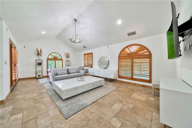 living room featuring high vaulted ceiling and a notable chandelier