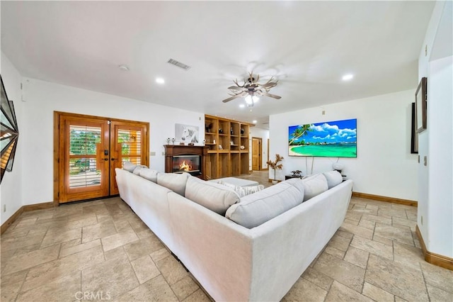 living room with ceiling fan and french doors