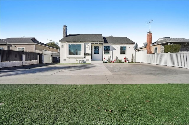 view of front of house featuring a front lawn and a patio