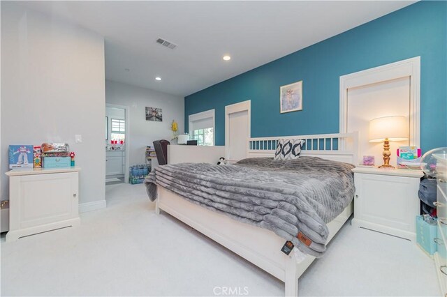 bedroom with light colored carpet