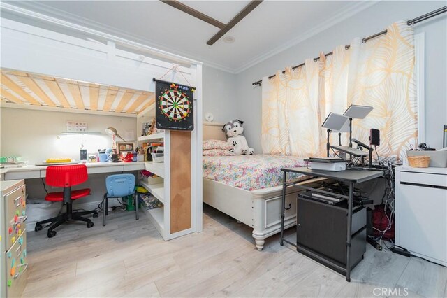 bedroom with ornamental molding and light hardwood / wood-style floors