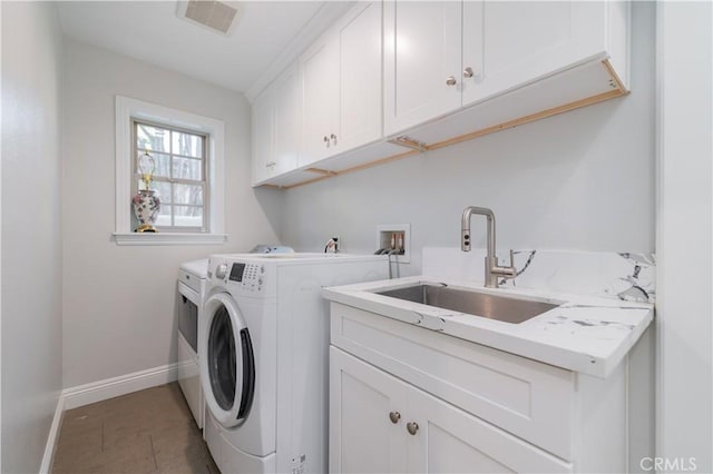 washroom with separate washer and dryer, sink, tile patterned flooring, and cabinets