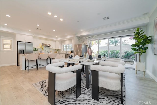 dining room with recessed lighting, visible vents, ornamental molding, light wood-style floors, and baseboards