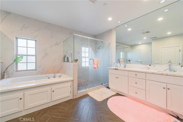 bathroom with parquet flooring, vanity, and shower with separate bathtub