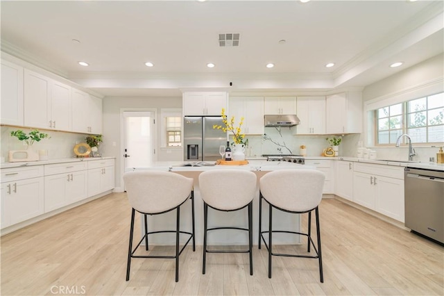 kitchen featuring white cabinetry, appliances with stainless steel finishes, and light hardwood / wood-style floors