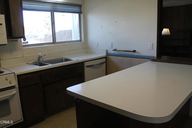 kitchen with sink, white appliances, and dark brown cabinetry