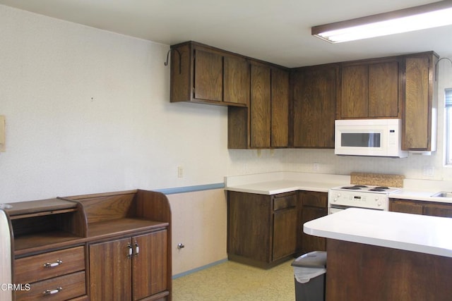 kitchen with dark brown cabinets and white appliances