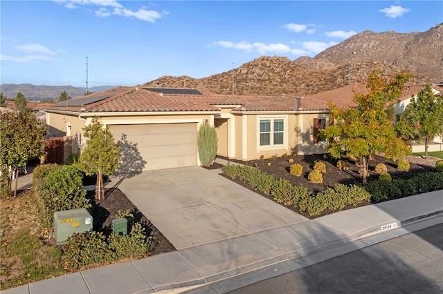 view of front of home with a mountain view and a garage