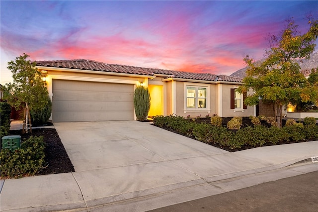 mediterranean / spanish house featuring a garage