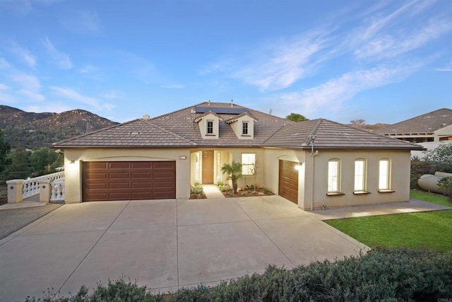 view of front of house with a mountain view and a garage