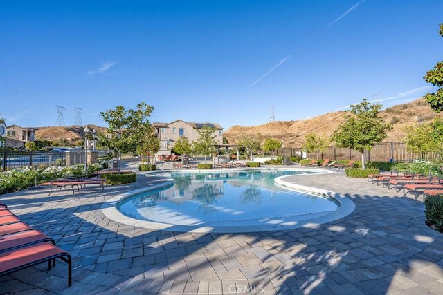 view of pool featuring a mountain view and a patio area