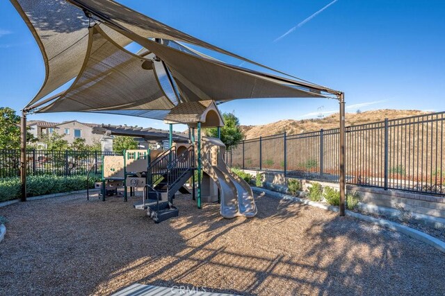 view of jungle gym with a mountain view