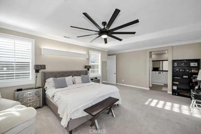 bedroom featuring light carpet, connected bathroom, ornamental molding, and ceiling fan