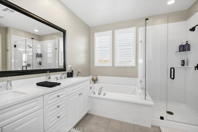 bathroom with tile patterned floors, independent shower and bath, and vanity