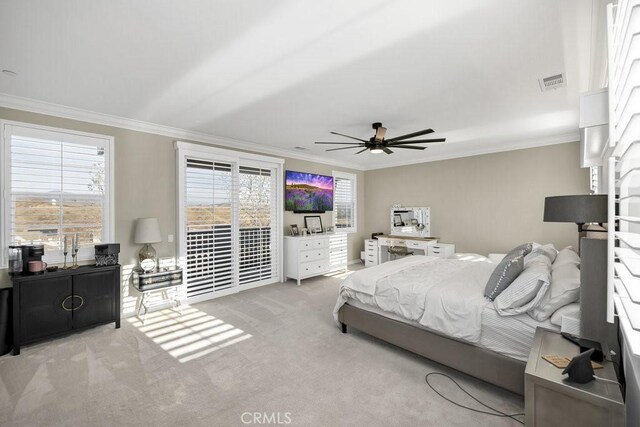 carpeted bedroom with crown molding, ceiling fan, multiple windows, and access to outside