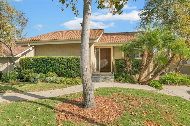 mediterranean / spanish-style home with a front yard